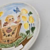 Ceramiczny talerz dekoracyjny z dzieckiem w kołysce – ręcznie malowany, Ø 17 cm