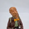Figurka ceramiczna starszy pan siedzący na beczce wysokość 22 cm